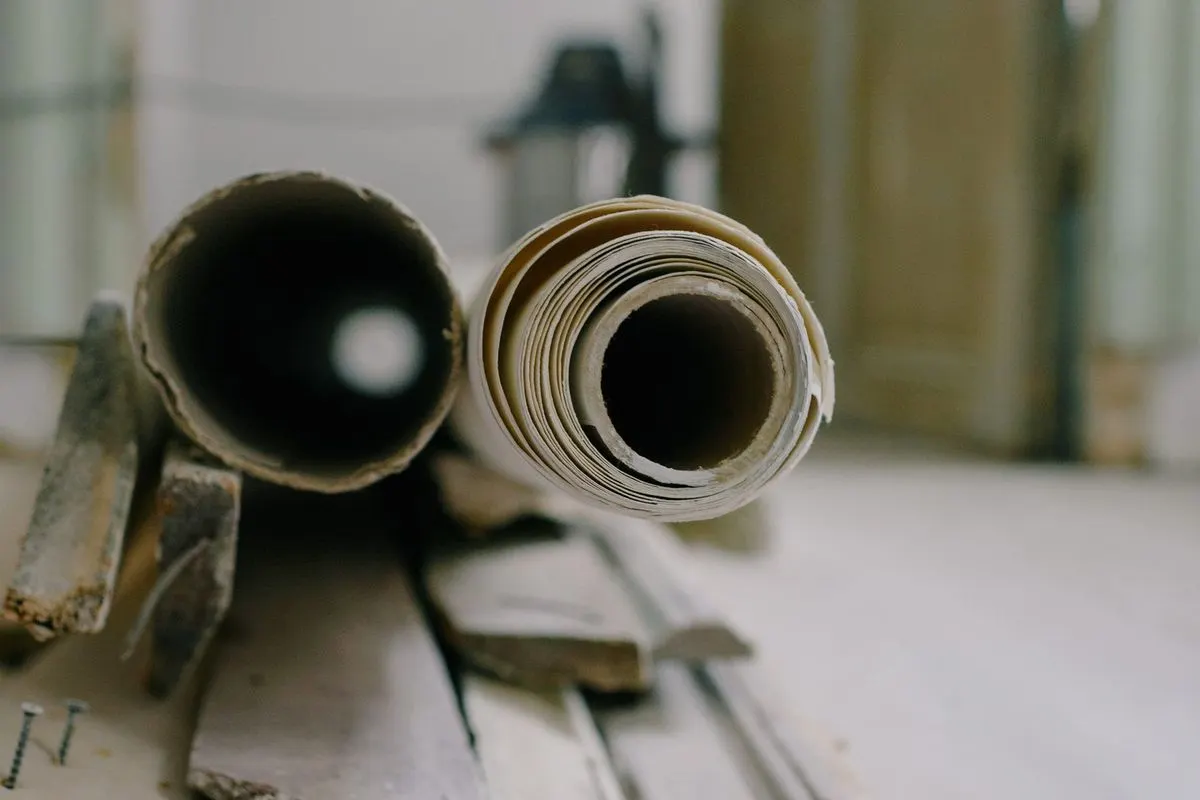 Rolls of old flooring and materials on the floor of a room during a renovation